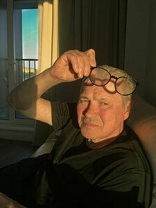 My father in the living room of their apartment.  May 2025. Yekaterinburg. Russia.