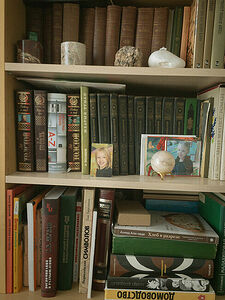 Bookshelves with the photos of my daughter in my parent’s apartment.  May 2025. Yekaterinburg. Russia.