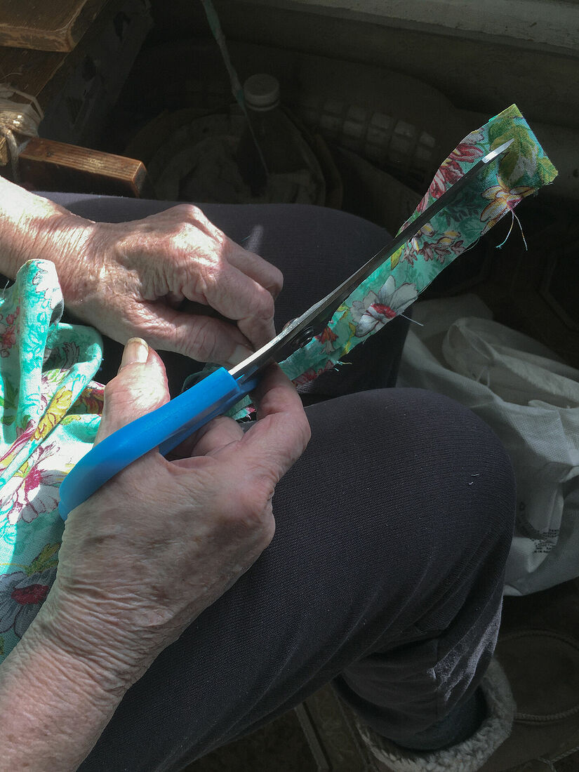 Natasha Golyzhbina Photography. Mom, I am not coming home this summer. Untitled Grandma is cutting the old clothes to make a carpet out of it. Russia, Krasnoufimsk. May 2025.