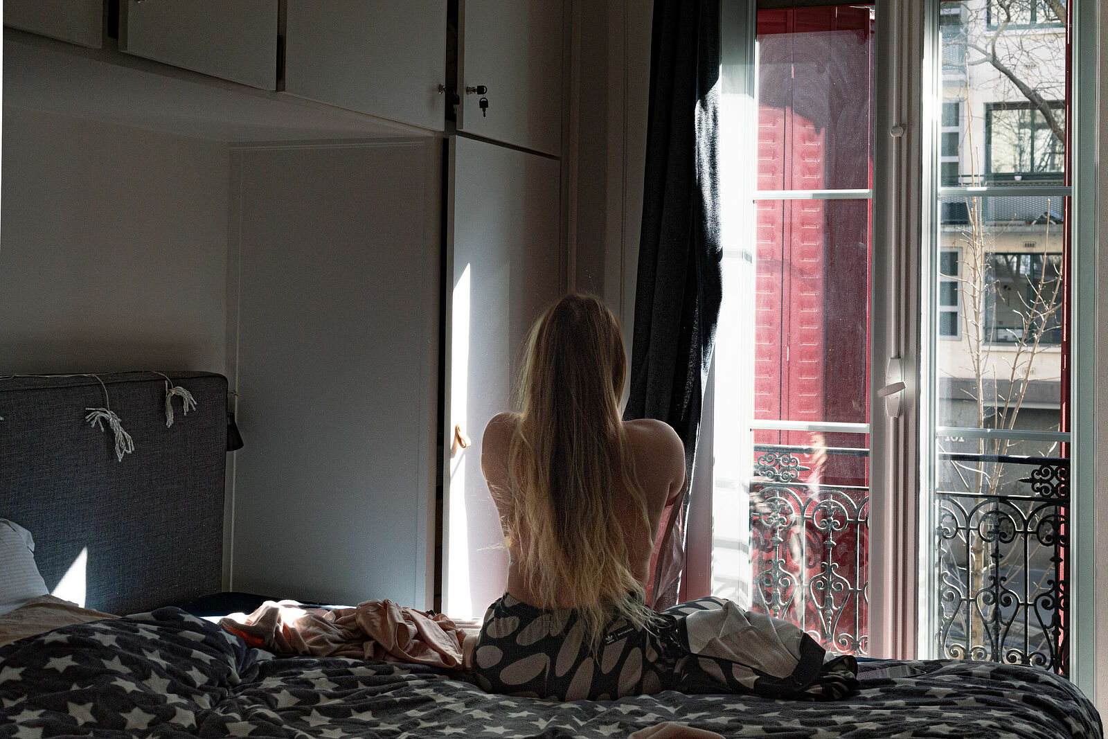 Vlada changing to get ready to go for the regular anonymous meeting. Paris, France. March 2025.