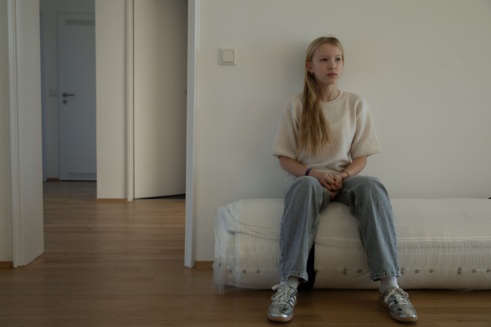 Masha in the new apartment her family is moving to soon. It will be Masha&rsquo;s 6th move in Germany in the last 10 years. December 2025. Düsseldorf, Germany.