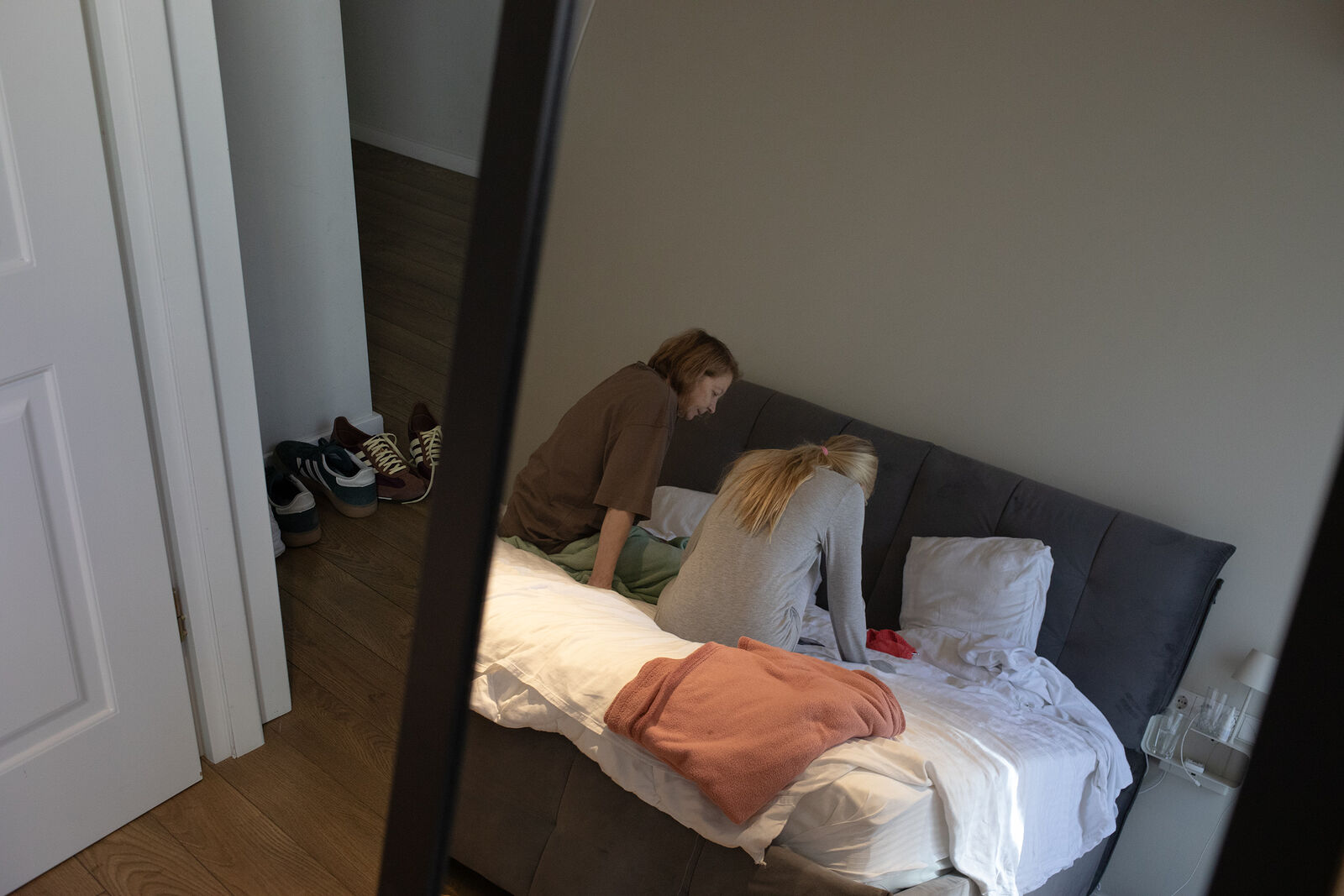 Masha and her grandmother looking at old photos. October 2025. Tbilisi, Georgia.