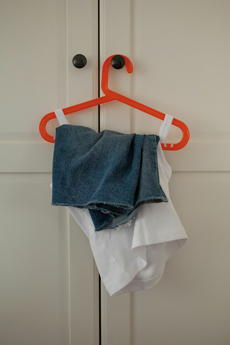 Masha prepared her clothes before her first day in new school after she moved with parents to another city. August 2024. Düsseldorf, Germany.